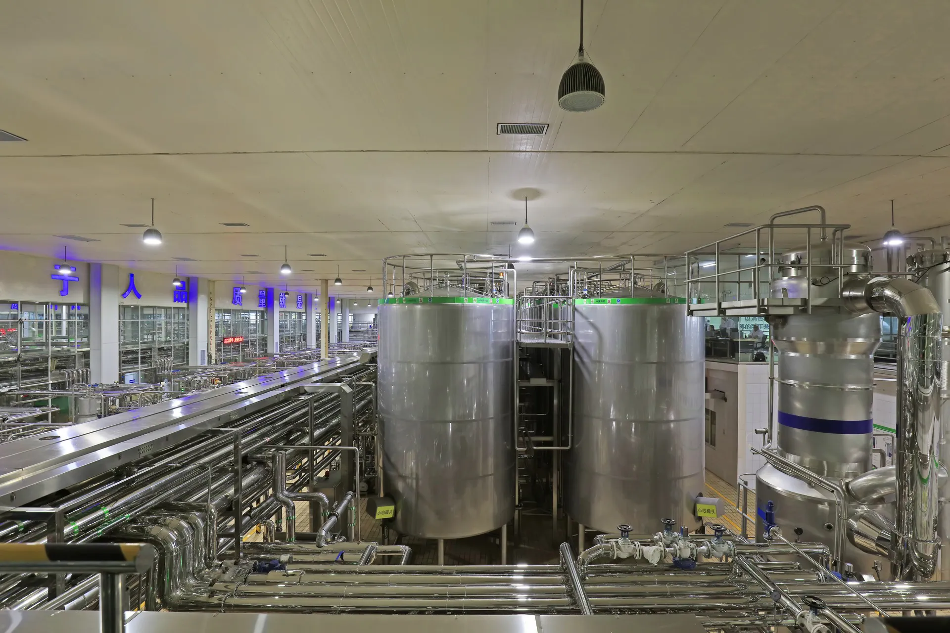 A stainless processing line receding into a dairy production plant in China
